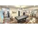 Spacious game room featuring a pool table, hardwood floors, and stylish lighting at 4564 Investors Ln, Ellenwood, GA 30294