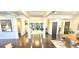 Open-concept great room featuring hardwood floors, columns, and tons of natural light at 4564 Investors Ln, Ellenwood, GA 30294
