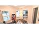 Bright hallway with hardwood floors and a view into the bedroom, illuminated by natural light at 4564 Investors Ln, Ellenwood, GA 30294