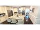 Bright kitchen features a large island with granite countertops, stainless steel appliances and eat in bar at 4564 Investors Ln, Ellenwood, GA 30294