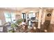 Open concept home with hardwood floors, elegant table set and piano room beyond at 4564 Investors Ln, Ellenwood, GA 30294