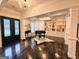 Open living room with tray ceiling, built-in shelving, piano, and dark hardwood floors at 4564 Investors Ln, Ellenwood, GA 30294