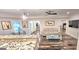 Bright living room features a bar area, hardwood floors, comfortable seating, and art at 4564 Investors Ln, Ellenwood, GA 30294