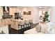 Modern kitchen with island and seating adjacent to living room, perfect for entertaining guests at 4564 Investors Ln, Ellenwood, GA 30294