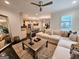 Bright open concept living room and kitchen with dark wood floors and comfortable seating at 4564 Investors Ln, Ellenwood, GA 30294