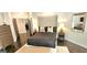 Spacious main bedroom boasts dark wood floors, comfortable bedding and coordinated furnishings at 4564 Investors Ln, Ellenwood, GA 30294