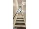 Clean staircase with dark wood steps and white risers leading up to a bright, inviting living space at 4564 Investors Ln, Ellenwood, GA 30294