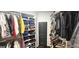 Spacious walk-in closet with custom shelving and hanging racks, offering ample storage and organization at 4564 Investors Ln, Ellenwood, GA 30294