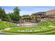 Outdoor amphitheater with terraced seating at The Bowl at Sugar Hill with a covered stage and lush greenery at 4972 Park Vale Dr, Sugar Hill, GA 30518