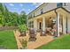 Beautiful backyard featuring a covered patio, dining area and lush lawn space at 4972 Park Vale Dr, Sugar Hill, GA 30518