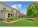Well-maintained backyard with a lush lawn, vegetable garden, and privacy fence at 4972 Park Vale Dr, Sugar Hill, GA 30518