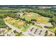 High aerial view of multiple well-maintained baseball fields, amenities, parking, surrounded by verdant trees in the community at 4972 Park Vale Dr, Sugar Hill, GA 30518