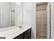 Bathroom with large vanity, white countertop and shower with striped curtain at 4972 Park Vale Dr, Sugar Hill, GA 30518