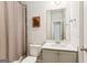 Cozy bathroom featuring a vanity with white countertop and shower with light brown curtain at 4972 Park Vale Dr, Sugar Hill, GA 30518