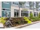 Building exterior showcasing a restaurant with a decorative waterfall feature and attractive landscaping at 4972 Park Vale Dr, Sugar Hill, GA 30518