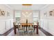 Traditional dining room featuring wainscoting, natural light and a stylish chandelier at 4972 Park Vale Dr, Sugar Hill, GA 30518