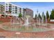 Beautiful water fountain surrounded by a brick walkway, landscaped with greenery, and brick building in background at 4972 Park Vale Dr, Sugar Hill, GA 30518