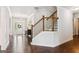 Bright foyer featuring hardwood floors, staircase, and natural light from the front door at 4972 Park Vale Dr, Sugar Hill, GA 30518