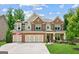 Beautiful brick and siding home with a three-car garage and well-manicured lawn at 4972 Park Vale Dr, Sugar Hill, GA 30518