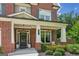 Charming brick home featuring a welcoming front porch with lovely landscaping at 4972 Park Vale Dr, Sugar Hill, GA 30518