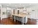 Bright kitchen features a large center island with seating and stainless steel appliances at 4972 Park Vale Dr, Sugar Hill, GA 30518