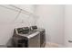 Modern laundry room equipped with a side-by-side stainless steel washer and dryer at 4972 Park Vale Dr, Sugar Hill, GA 30518
