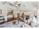 Open-concept living space with hardwood floors, coffered ceiling, and ample seating at 4972 Park Vale Dr, Sugar Hill, GA 30518
