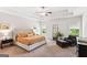 Relaxing main bedroom suite with a tray ceiling and a seating area at 4972 Park Vale Dr, Sugar Hill, GA 30518