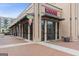Exterior view of shops with a brightly lit ice cream parlor, outdoor seating, and an inviting storefront in the shopping district at 4972 Park Vale Dr, Sugar Hill, GA 30518