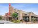 Front view of a restored theater showcasing architectural charm with a coffee shop nearby, providing entertainment and convenience at 4972 Park Vale Dr, Sugar Hill, GA 30518