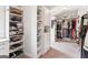 Spacious walk-in closet with custom shelving and ample storage space at 4972 Park Vale Dr, Sugar Hill, GA 30518
