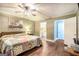 Main bedroom with wood floors, ceiling fan and en suite bathroom at 1083 Hampton Rd, Hampton, GA 30228