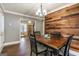 Dining room with wooden table, wood accent wall, and decorative lighting at 1083 Hampton Rd, Hampton, GA 30228