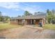 Charming brick home featuring a convenient carport and well-maintained landscaping at 1083 Hampton Rd, Hampton, GA 30228