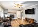 Comfortable living room with a fireplace, wood floors, large screen TV, and leather furniture at 1083 Hampton Rd, Hampton, GA 30228