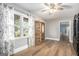 Sunlit living room featuring hardwood floors and an elegant display cabinet at 1083 Hampton Rd, Hampton, GA 30228