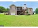 Expansive brick home showcasing a sprawling green backyard, wooden deck with screened in porch, and an attached two-car garage at 186 Ashley Dr, Mcdonough, GA 30252