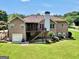 Expansive brick home showcasing a sprawling green backyard, wooden deck with screened in porch, and an attached two-car garage at 186 Ashley Dr, Mcdonough, GA 30252