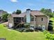 Expansive brick home showcasing a sprawling green backyard, wooden deck with screened in porch, and an attached two-car garage at 186 Ashley Dr, Mcdonough, GA 30252