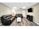 Open basement living room featuring laminate floors, recessed lighting, a fireplace, and leather sofas at 186 Ashley Dr, Mcdonough, GA 30252