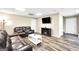 Basement living room featuring laminate floors, a fireplace, and two leather sofas at 186 Ashley Dr, Mcdonough, GA 30252