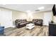 Finished basement living room with two leather sofas, luxury vinyl flooring, and recessed lighting at 186 Ashley Dr, Mcdonough, GA 30252