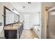 A bathroom boasts a granite countertop with dual sinks, an oversized mirror, a bathtub, and a shower at 186 Ashley Dr, Mcdonough, GA 30252