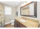 Well-lit bathroom featuring a granite vanity, large mirror, and seashell themed shower curtain at 186 Ashley Dr, Mcdonough, GA 30252