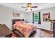 A charming bedroom offers hardwood floors, a ceiling fan, and a window view of the outdoors at 186 Ashley Dr, Mcdonough, GA 30252