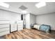 Basement bedroom with vinyl floors, white brick wall, and simple decor at 186 Ashley Dr, Mcdonough, GA 30252