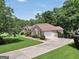 Charming single-story brick home featuring an attached garage and well-maintained landscaping on a sunny day at 186 Ashley Dr, Mcdonough, GA 30252