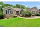 Charming brick home with well-manicured lawn, mature landscaping, and arched windows at 186 Ashley Dr, Mcdonough, GA 30252