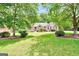 Inviting brick home with mature trees framing the well-kept lawn at 186 Ashley Dr, Mcdonough, GA 30252