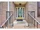 Close-up of an elegant front door with decorative glass and brick surround at 186 Ashley Dr, Mcdonough, GA 30252